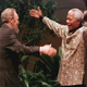 South African President Nelson Mandela (R) greets Cuban leader Fidel Castro as he arrives for the opening of the 12th Non-Aligned Movement summit in Durban on September 2, 1998. Castro resigned Tuesday as president and commander in chief of Cuba in a message published in the online version of the official daily Granma. AFP PHOTO (Photo credit should read ODD ANDERSEN/AFP/Getty Images)